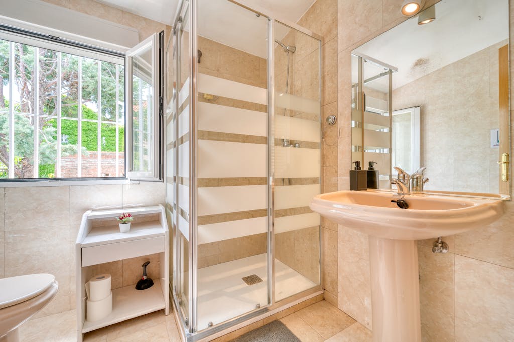 A bright and modern bathroom featuring a sleek glass shower and minimalist design.