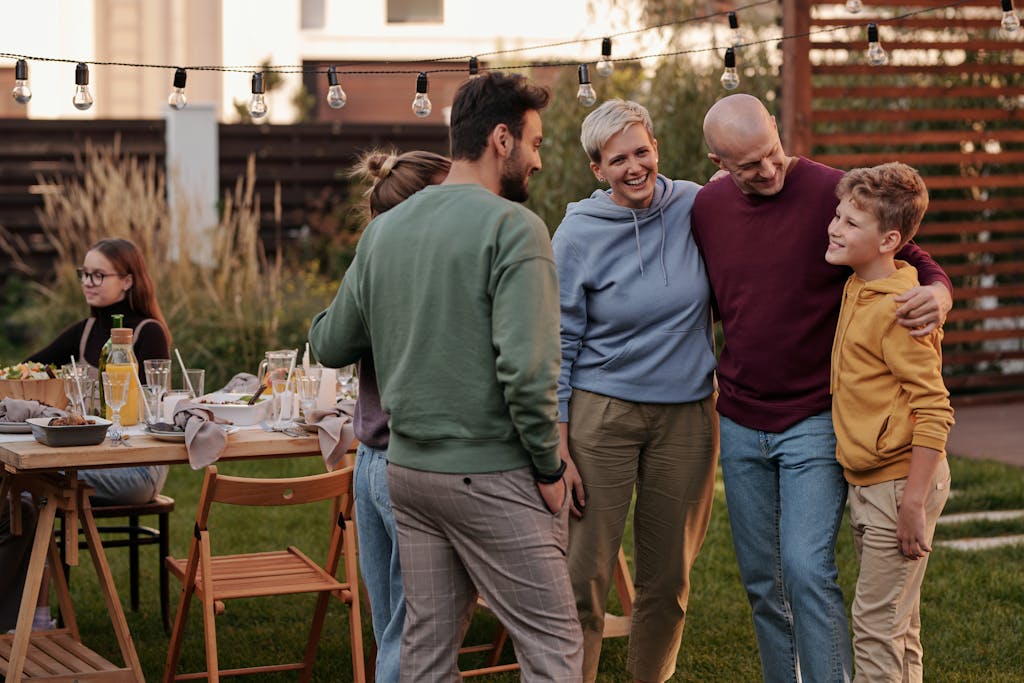 Family and friends enjoying a summer garden gathering with food and laughter.