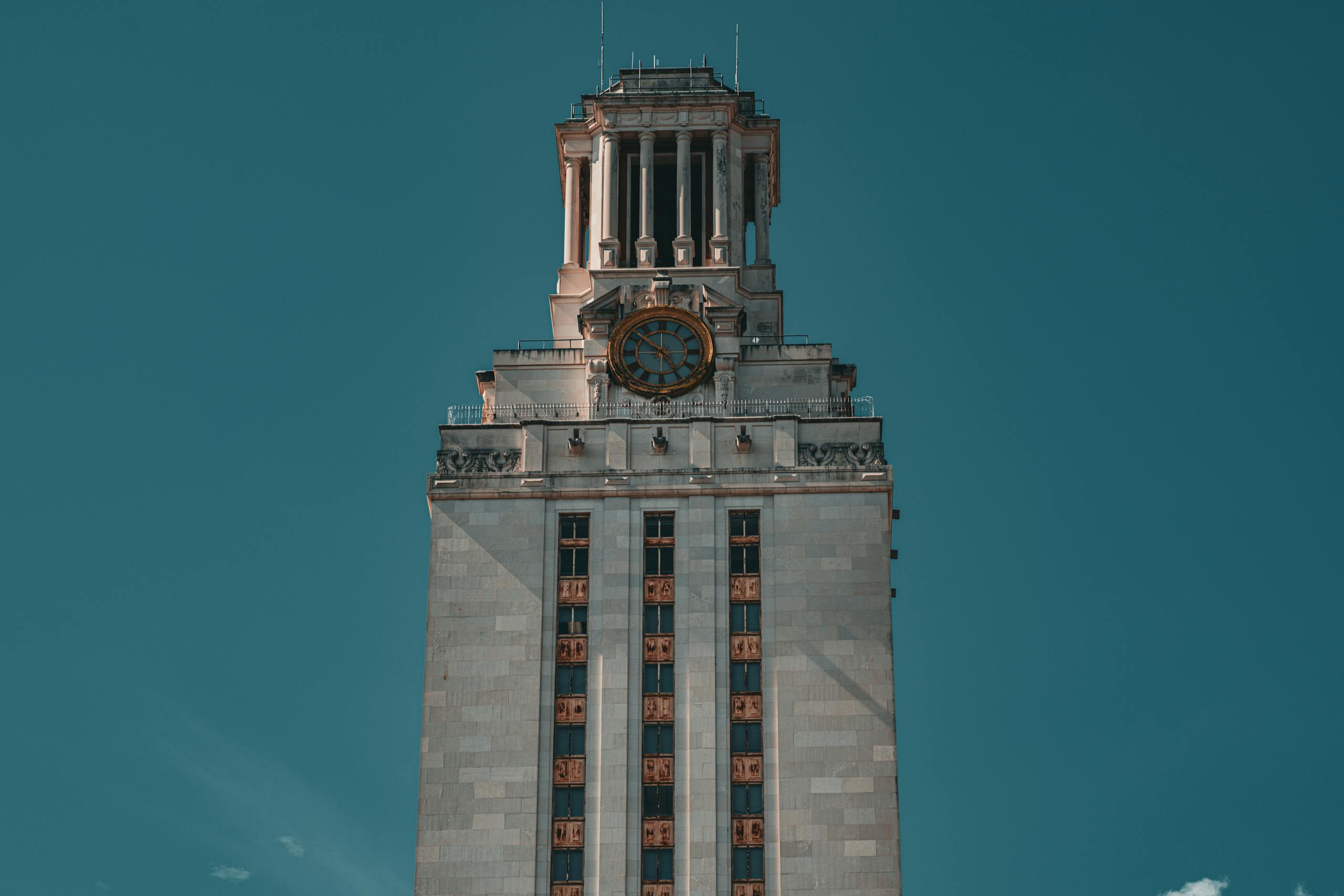 The University of Texas Tower against a clear blue sky in Austin, Texas.